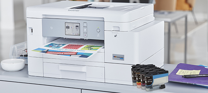 Brother’s MFC-J4535DW inkjet printer on a desk, with ink cartridges